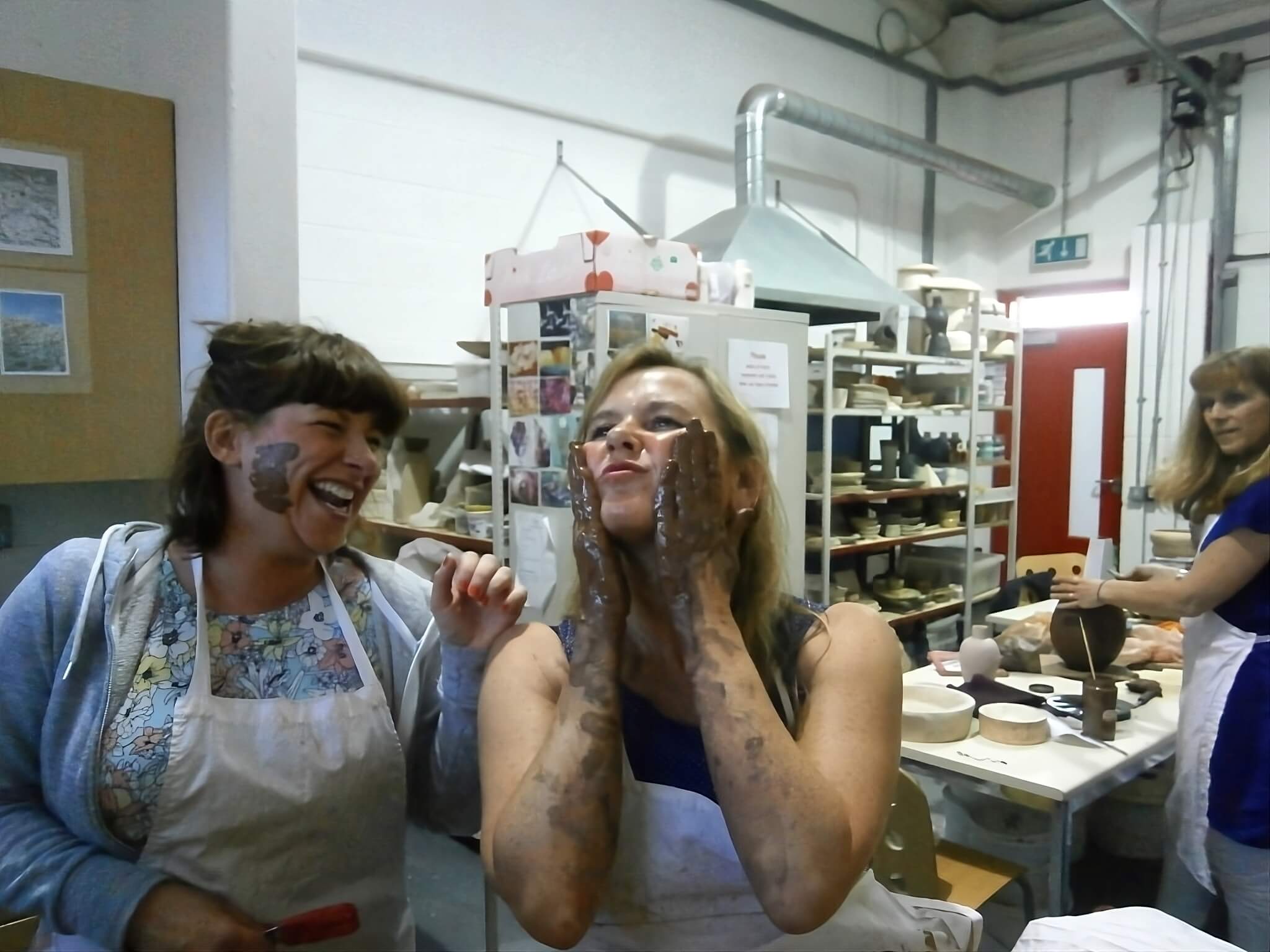 2 women laughing and having fun in a pottery class at 7 Limes pottery Manchester