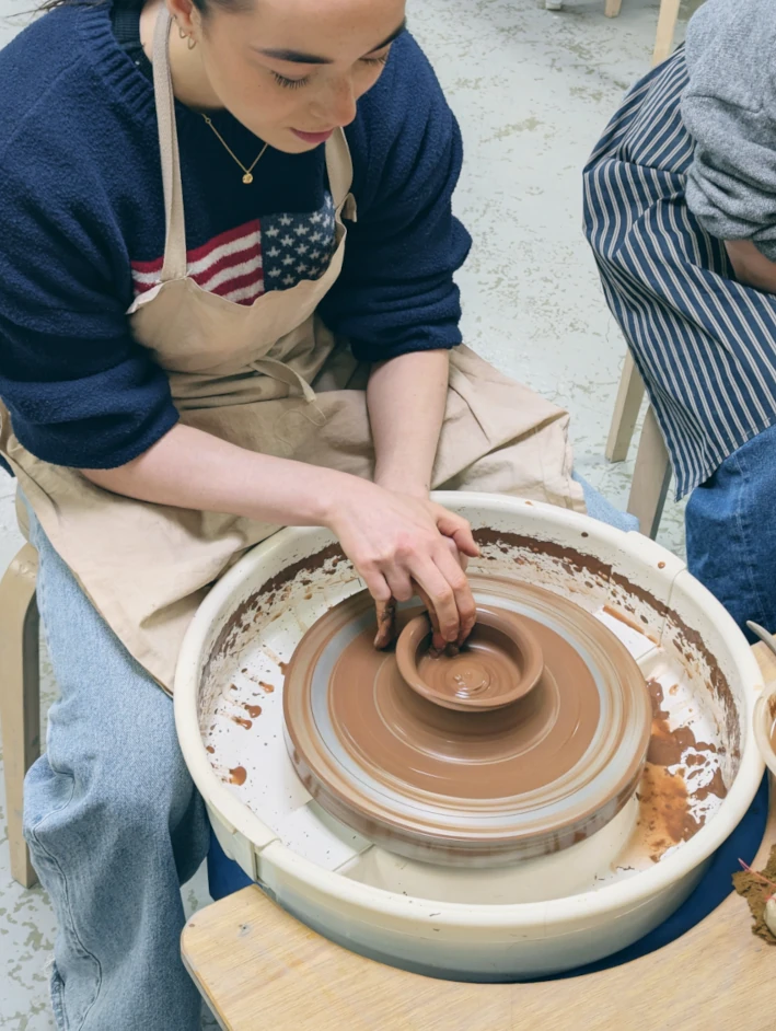 A guest at a hen party on the the potters wheel
